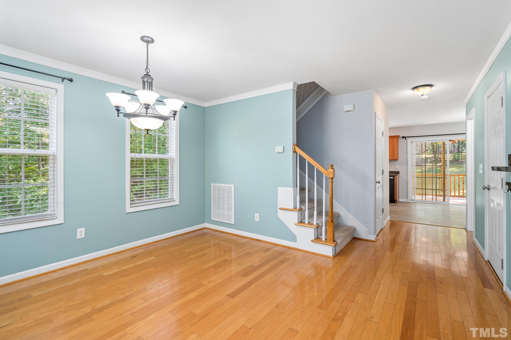 130 Broken Lance Drive Youngsville, NC 27596 - Photo 5 of 32 a view of an empty room with wooden floor and a window