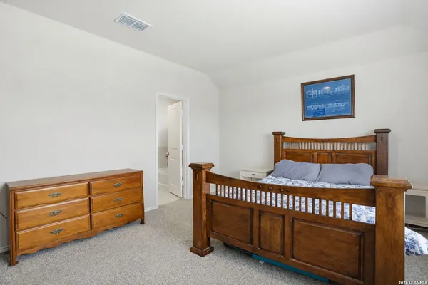 a bedroom with furniture and a dresser