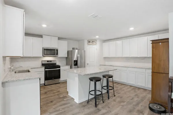a kitchen with cabinets stainless steel appliances a sink and a counter top space