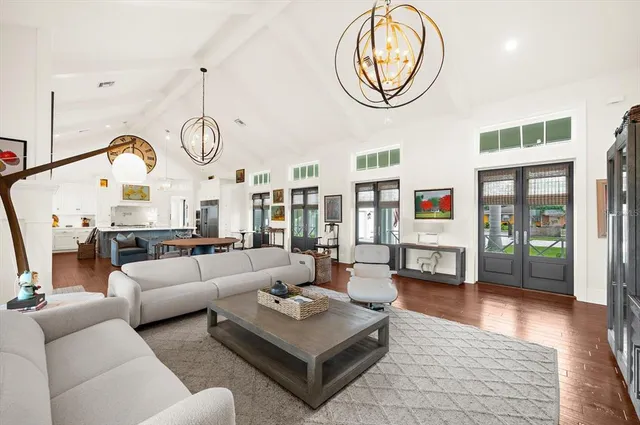 a living room with furniture a flat screen tv and a window