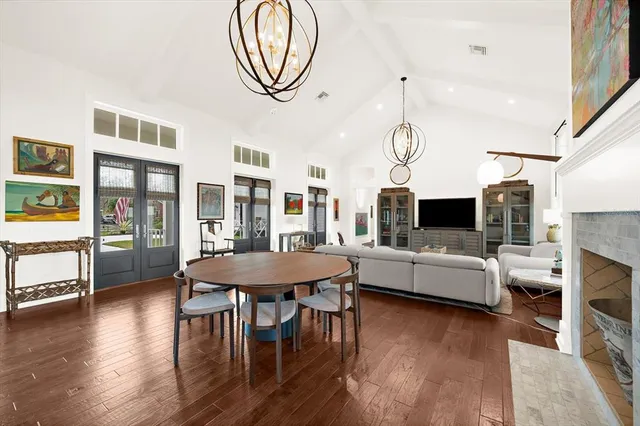 a large white kitchen with stainless steel appliances granite countertop a stove and a sink