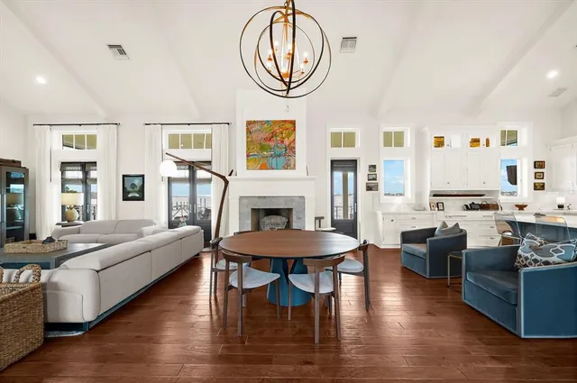 a living room with furniture kitchen view and a large window