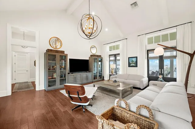 a living room with fireplace furniture and a large window