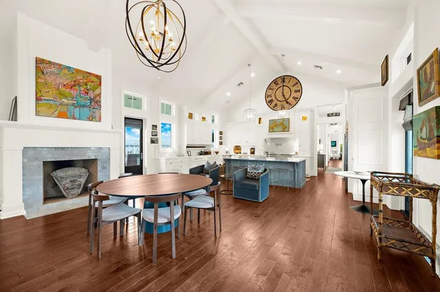 a very nice looking living room with kitchen island furniture a rug and a kitchen view