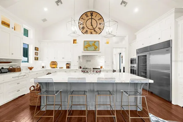 a large kitchen with stainless steel appliances and a counter space