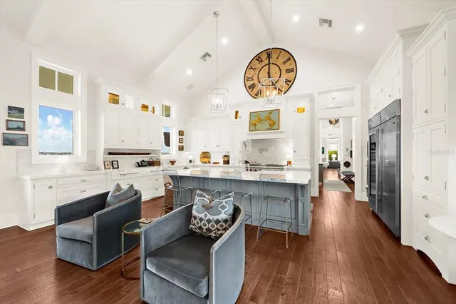 a living room with fireplace furniture and a floor to ceiling window