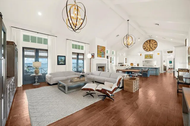 a spacious bedroom with a bed couch and a window