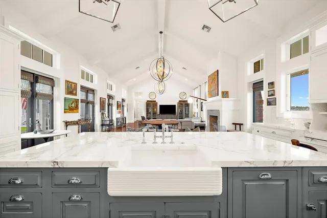 a view of a large living room with wooden floor and windows
