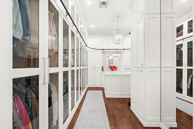 a view of swimming pool with lawn chairs floor to ceiling window and yard