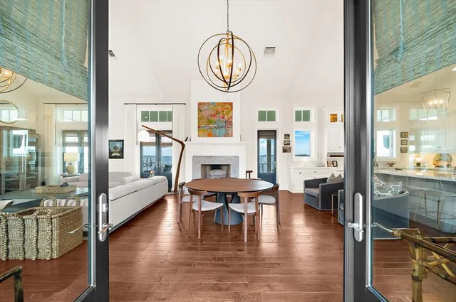 a living room with fireplace furniture and a wooden floor