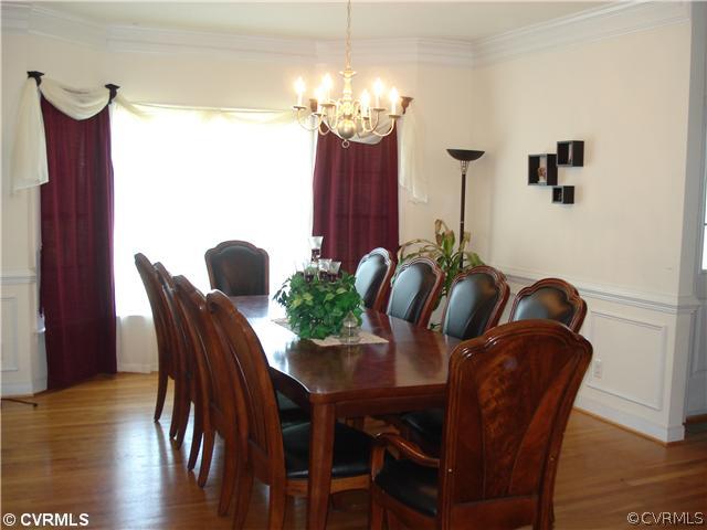 10907 Church Point Road Chesterfield, VA 23832 - Photo 2 of 7 a dining room with furniture potted plants and wooden floor