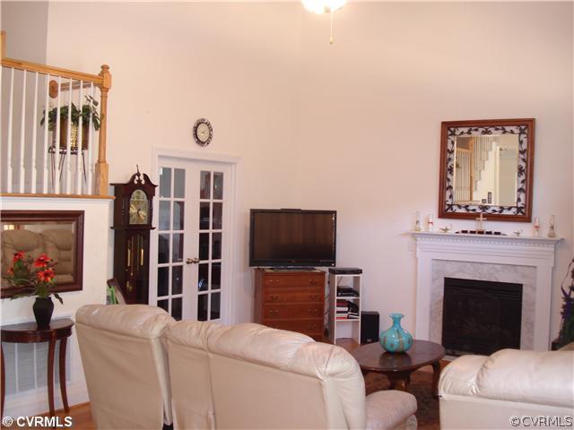 10907 Church Point Road Chesterfield, VA 23832 - Photo 3 of 7 a living room with furniture a fireplace and a flat screen tv