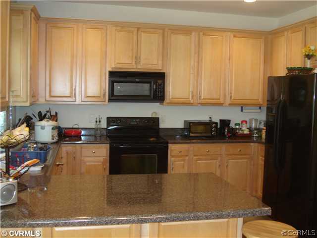 10907 Church Point Road Chesterfield, VA 23832 - Photo 4 of 7 a kitchen with granite countertop a refrigerator stove and sink