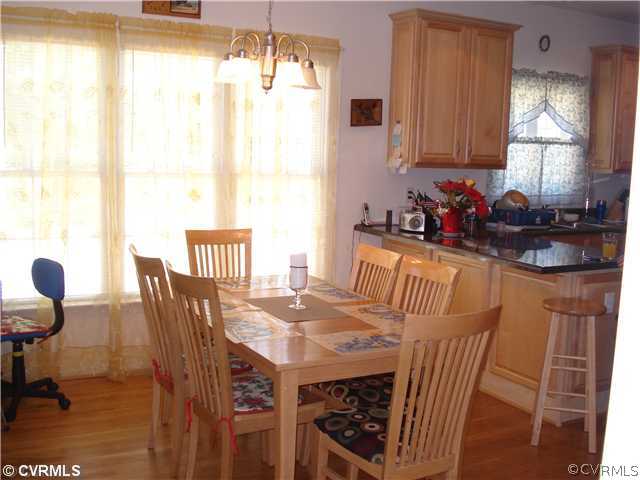 10907 Church Point Road Chesterfield, VA 23832 - Photo 5 of 7 a view of a dining room with furniture and a chandelier