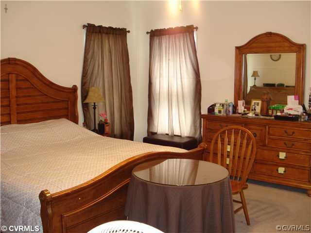 10907 Church Point Road Chesterfield, VA 23832 - Photo 6 of 7 a bedroom with a bed and wooden floor