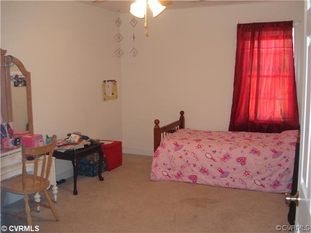 10907 Church Point Road Chesterfield, VA 23832 - Photo 7 of 7 a bedroom with a bed and a chandelier