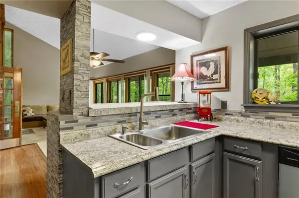 a kitchen with a sink stove and cabinets