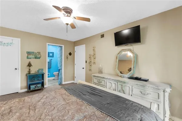 a view of an empty room with a window and closet area