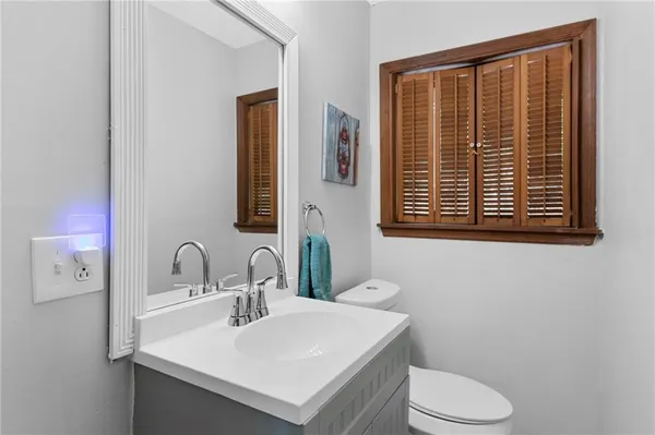 a bathroom with a sink a toilet and mirror