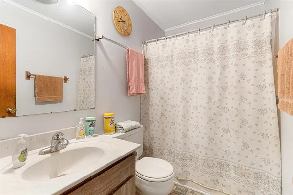 a bathroom with a sink a toilet and a mirror
