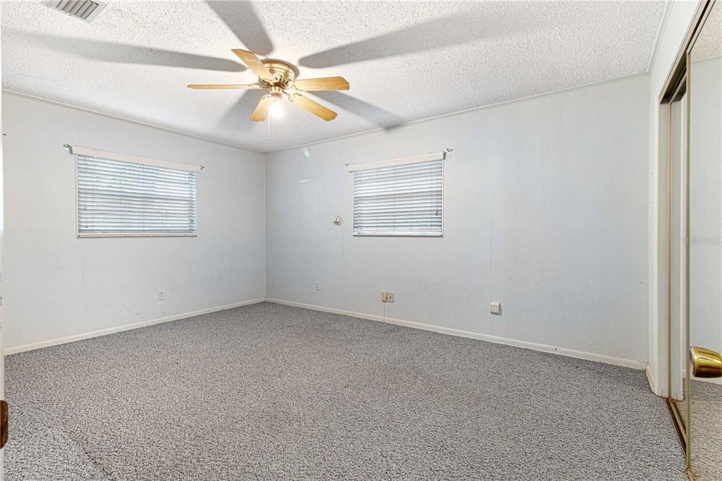 3350 Northeast 125th Terrace Road Silver Springs, FL 34488 - Photo 36 of 47 an empty room with windows and fan