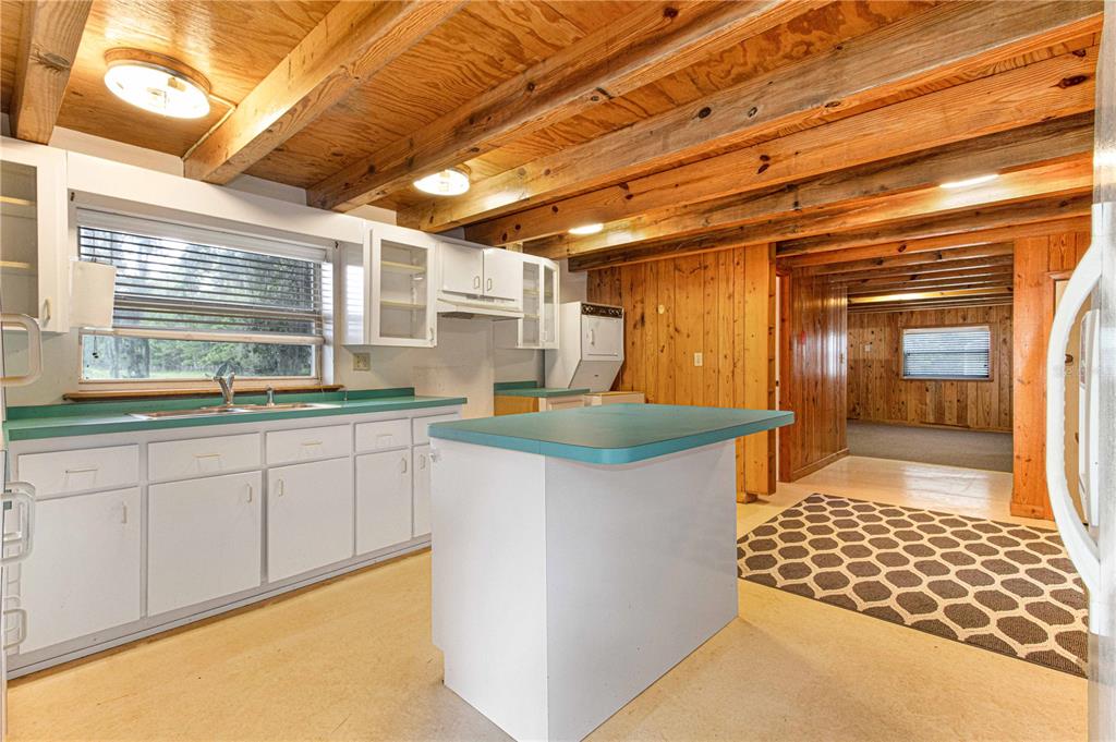 3350 Northeast 125th Terrace Road Silver Springs, FL 34488 - Photo 40 of 47 a kitchen that has a sink and a stove