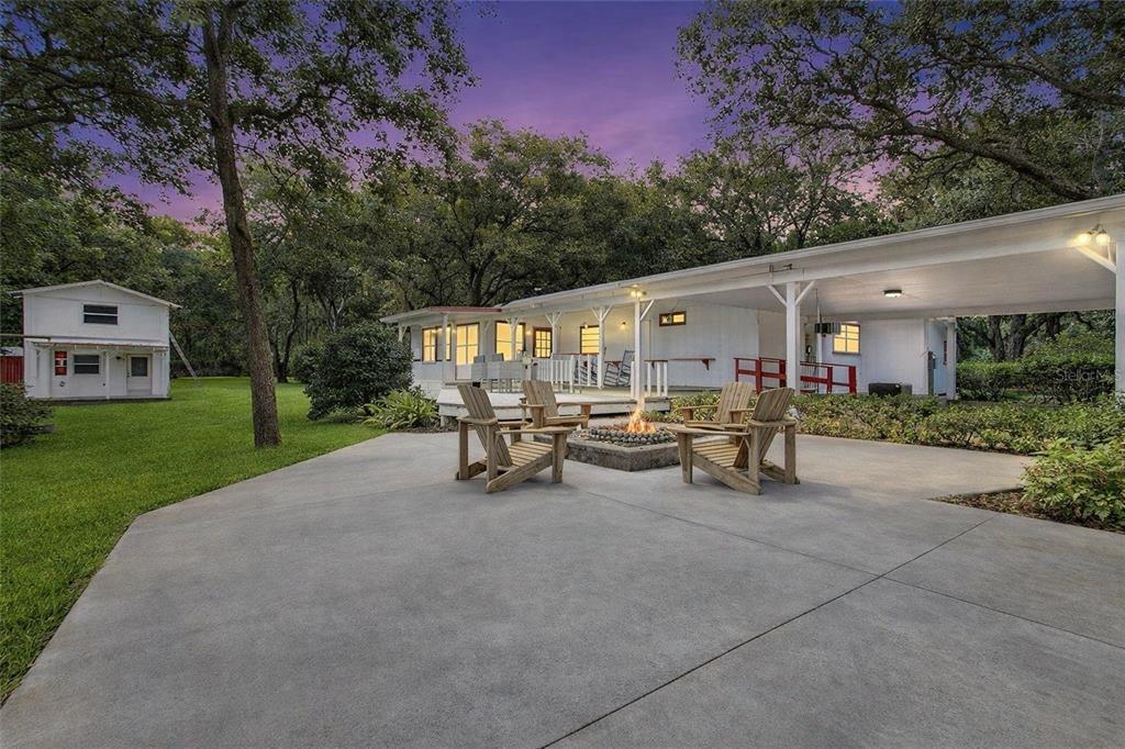 3350 Northeast 125th Terrace Road Silver Springs, FL 34488 - Photo 7 of 47 a view of a patio with table and chairs and a large tree