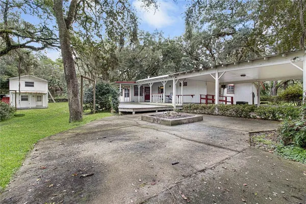 a front view of a house with a yard and trees