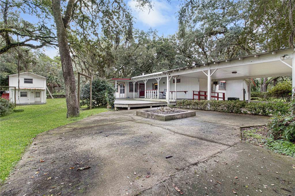 3350 Northeast 125th Terrace Road Silver Springs, FL 34488 - Photo 9 of 47 a front view of a house with a yard and trees