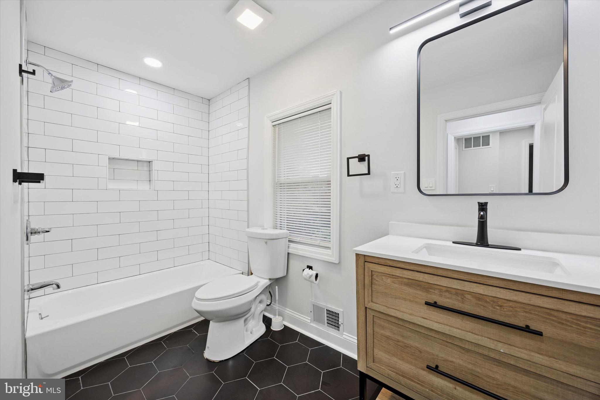 229 New Jersey Avenue, Unit B Collingswood, NJ 08108 - Photo 12 of 18 a bathroom with a toilet sink and mirror