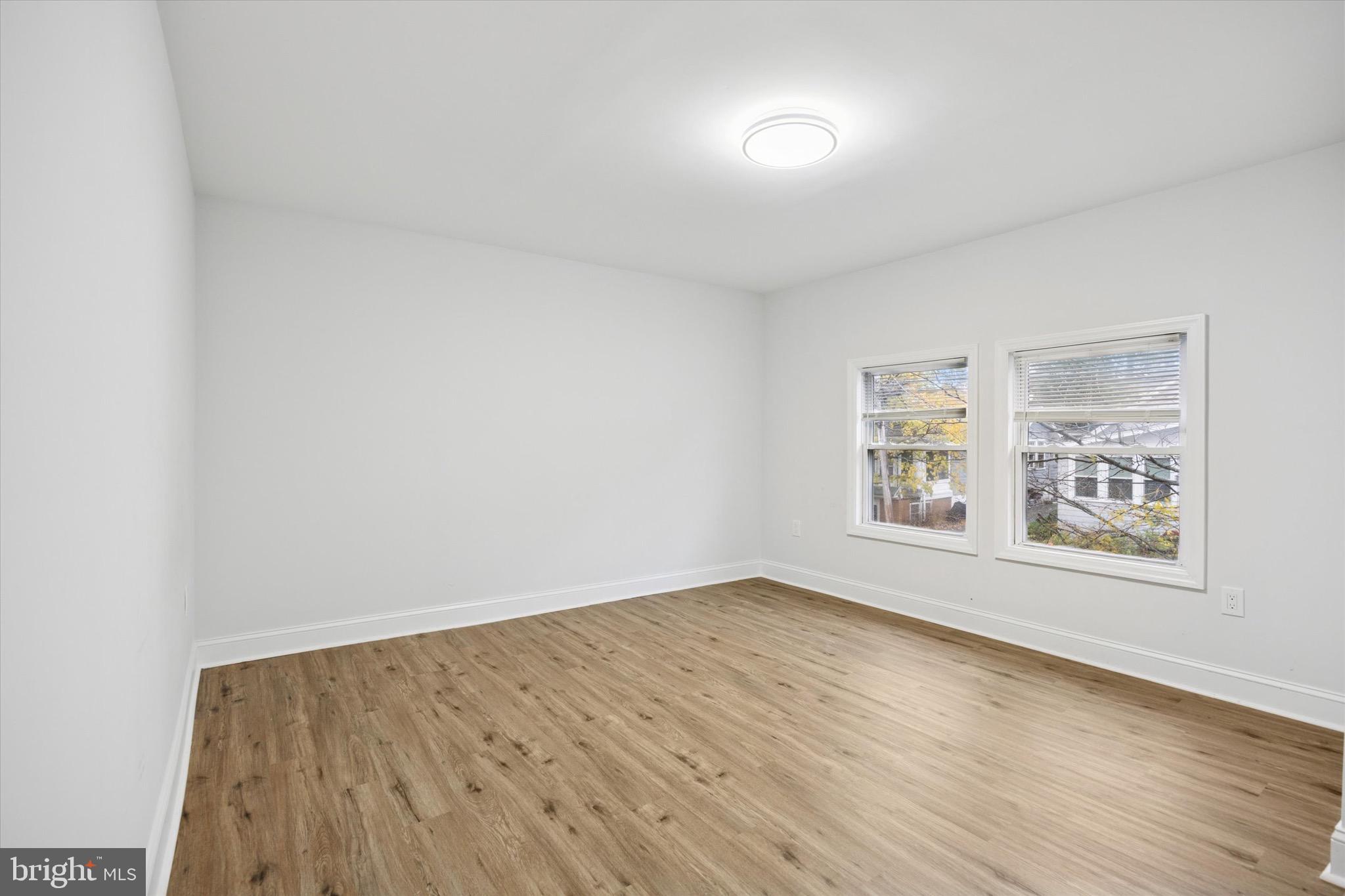229 New Jersey Avenue, Unit B Collingswood, NJ 08108 - Photo 13 of 18 an empty room with wooden floor and windows