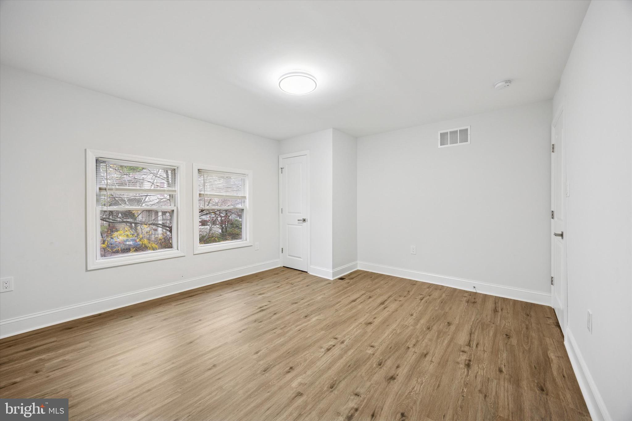 229 New Jersey Avenue, Unit B Collingswood, NJ 08108 - Photo 14 of 18 an empty room with wooden floor and window
