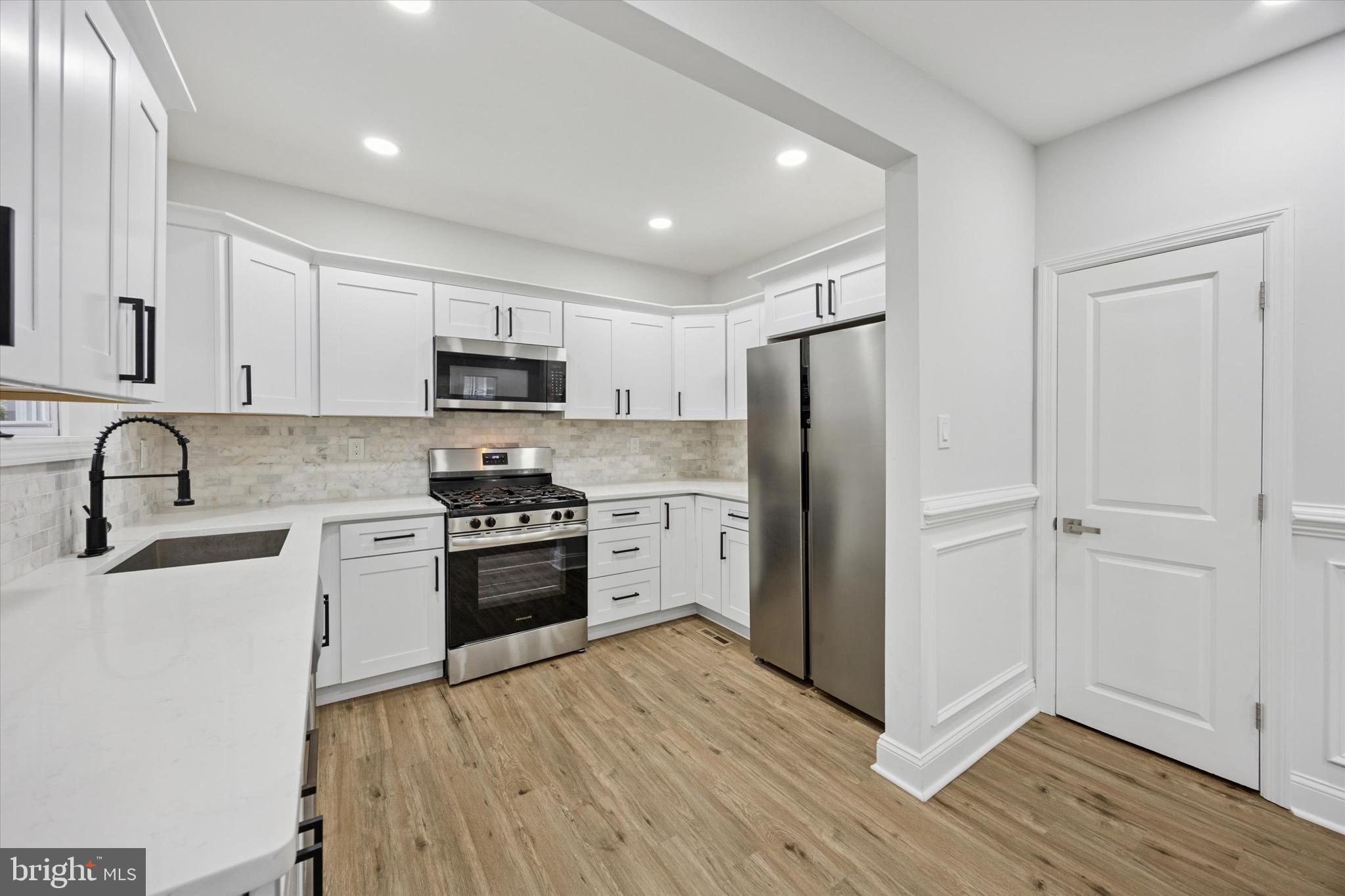 229 New Jersey Avenue, Unit B Collingswood, NJ 08108 - Photo 6 of 18 a kitchen with granite countertop a refrigerator stove and sink