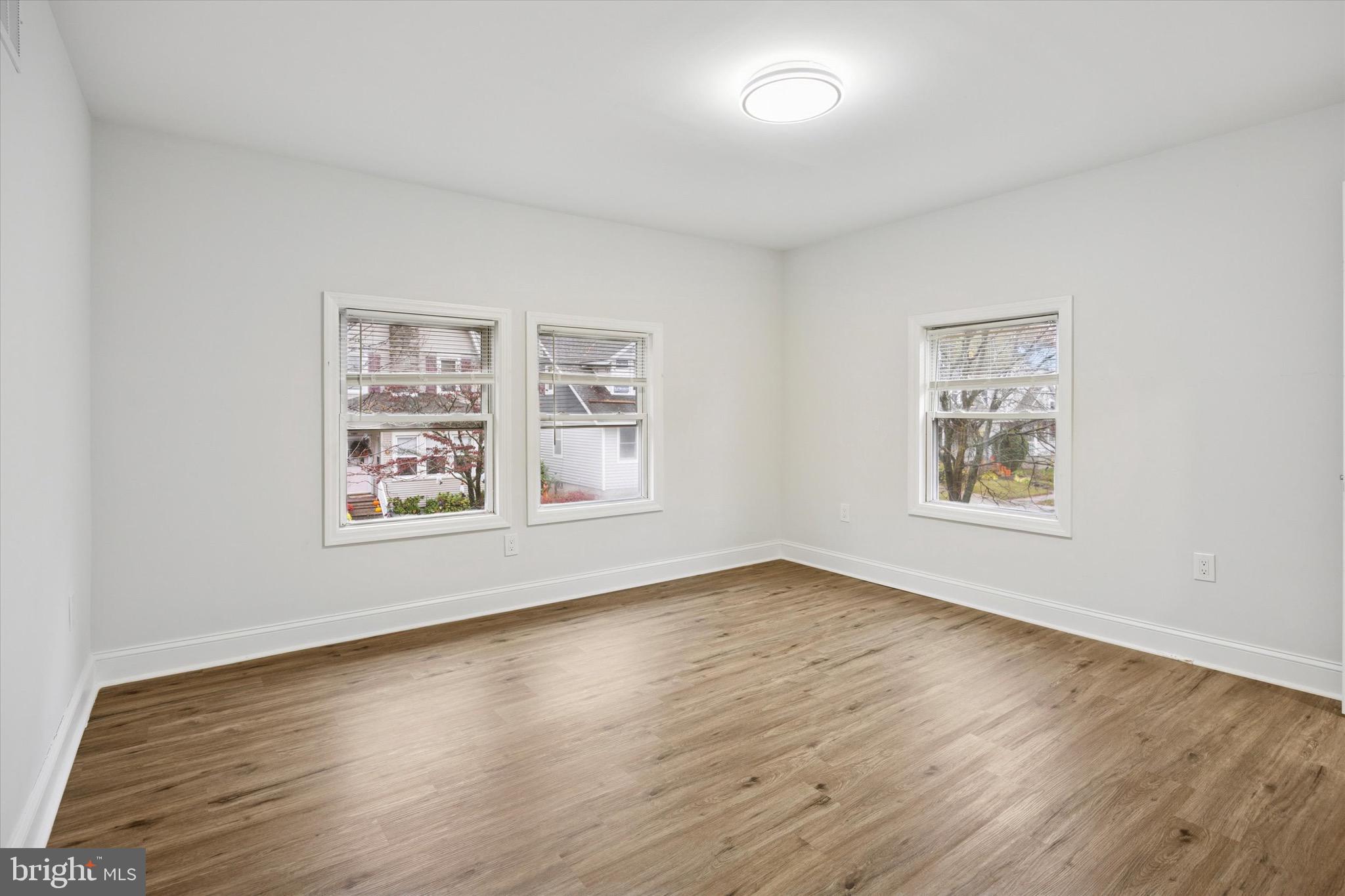 229 New Jersey Avenue, Unit B Collingswood, NJ 08108 - Photo 9 of 18 a view of an empty room with window and wooden floor