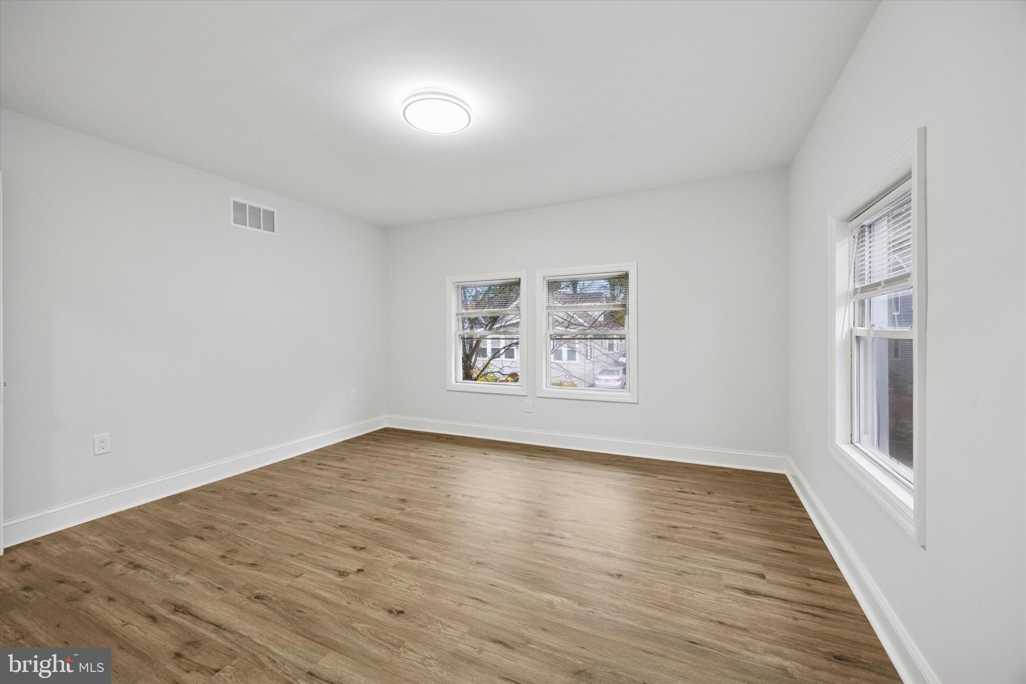 229 New Jersey Avenue, Unit B Collingswood, NJ 08108 - Photo 10 of 18 a view of an empty room with wooden floor and a window