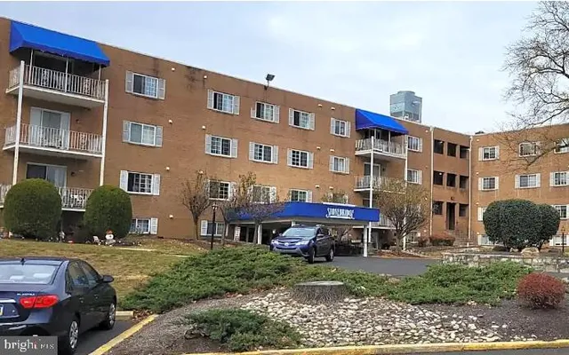 a car parked in front of a brick house