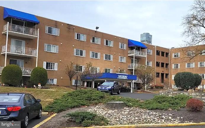 a car parked in front of a brick house