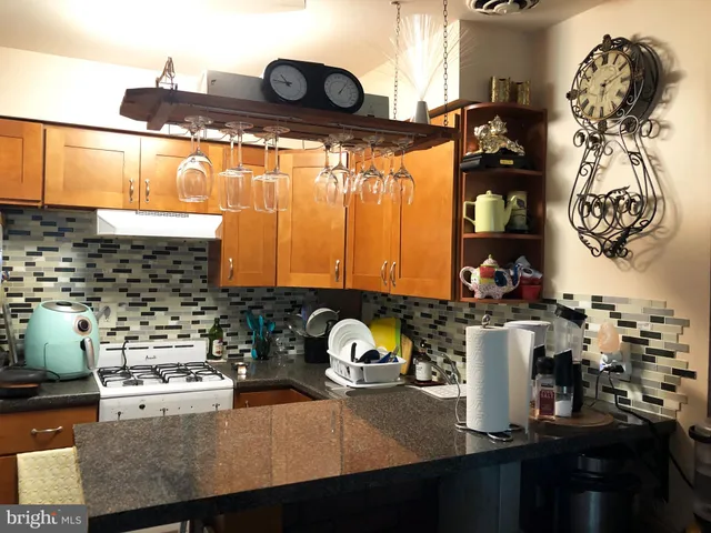 a kitchen with a sink a stove and a stove