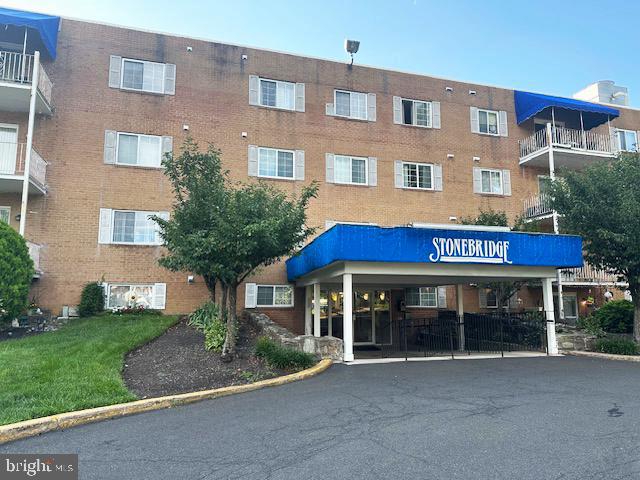 300 Byberry Road, Unit 303 Philadelphia, PA 19116 - Photo 5 of 5 a view of a brick building with a yard