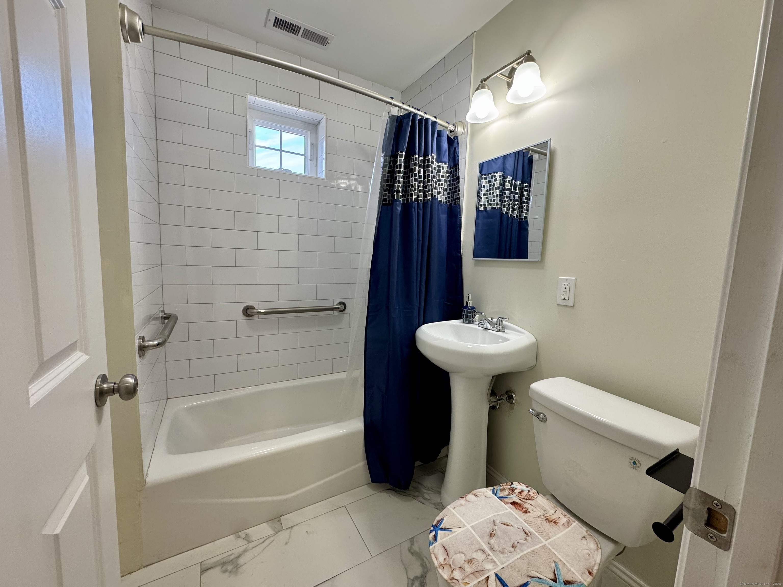 950 Lindley Street Bridgeport, CT 06606 - Photo 12 of 14 a bathroom with a sink a toilet and shower