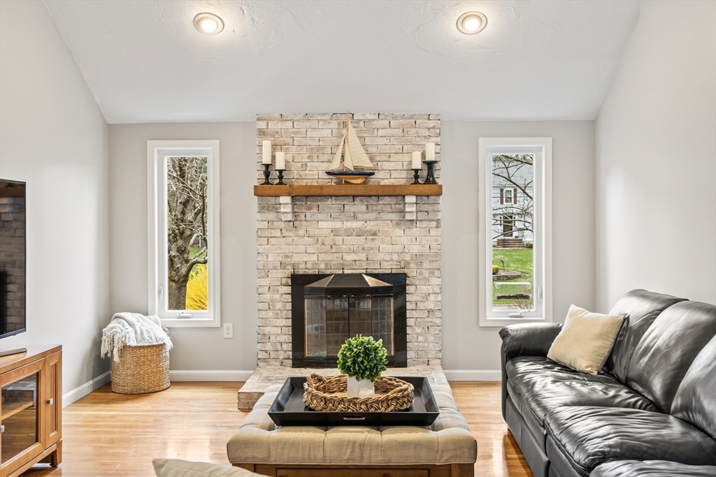 5 Strawberry Lane Norfolk, MA 02056 - Photo 11 of 42 a living room with furniture and a fireplace