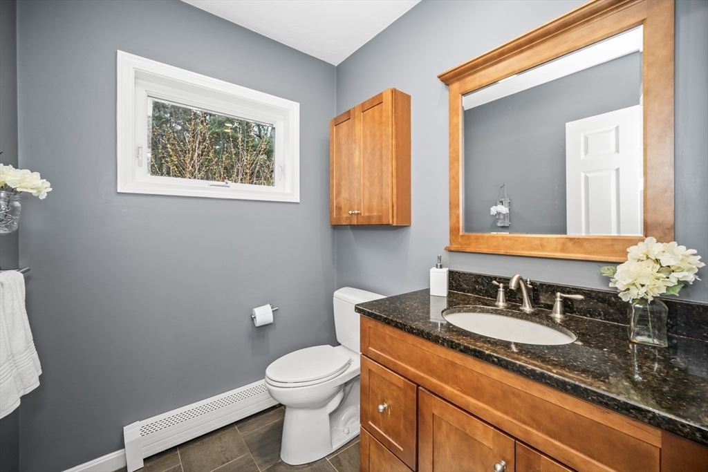5 Strawberry Lane Norfolk, MA 02056 - Photo 15 of 42 a bathroom with a toilet a sink and mirror