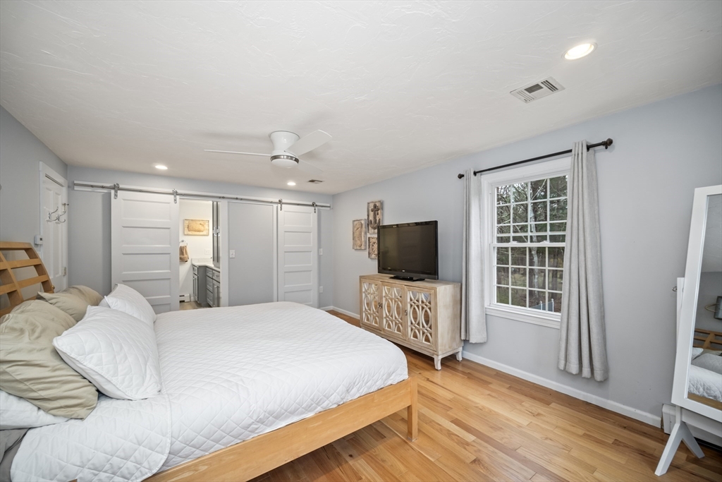 5 Strawberry Lane Norfolk, MA 02056 - Photo 20 of 42 a bedroom with a bed and a flat screen tv
