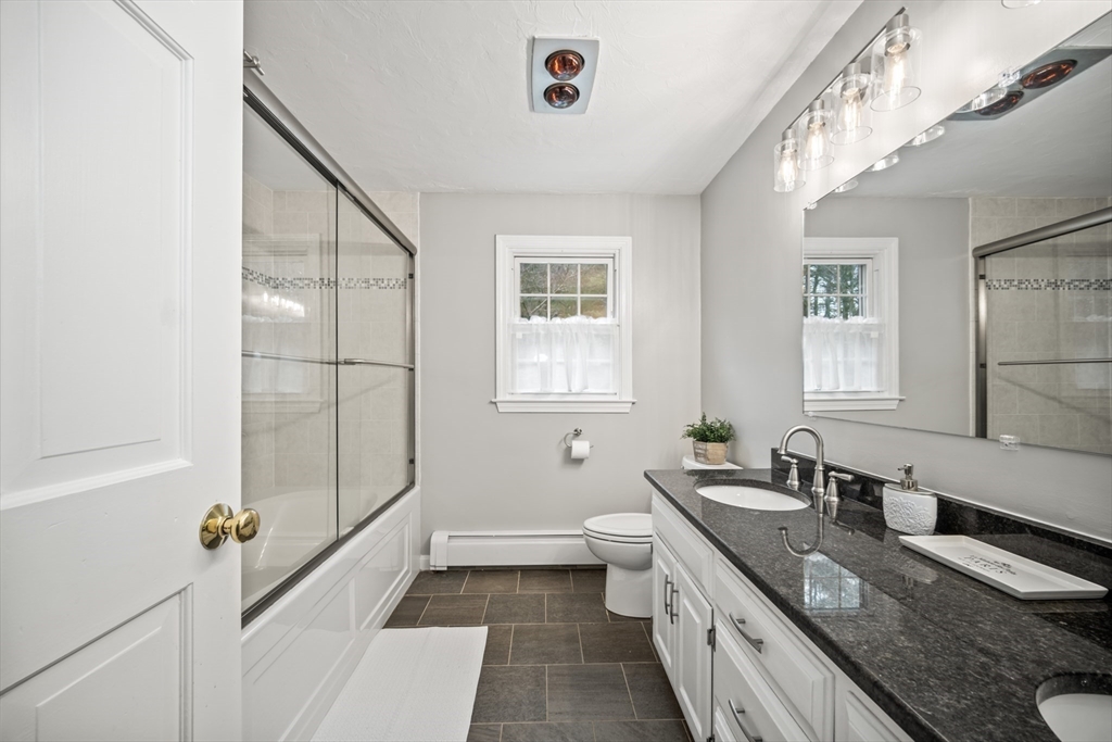 5 Strawberry Lane Norfolk, MA 02056 - Photo 24 of 42 a bathroom with a granite countertop sink mirror vanity and a bathtub