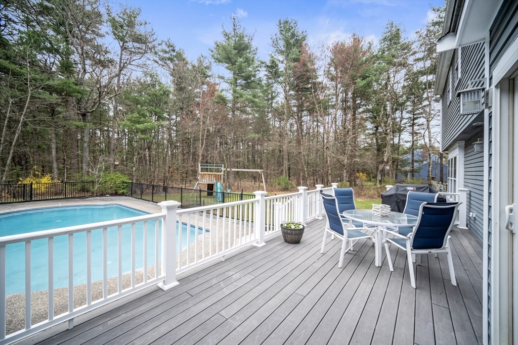 5 Strawberry Lane Norfolk, MA 02056 - Photo 30 of 42 a view of a deck with furniture and trees around