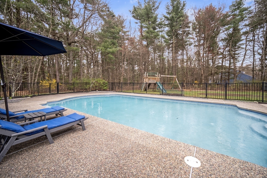 5 Strawberry Lane Norfolk, MA 02056 - Photo 33 of 42 a backyard view with a seating space and trees