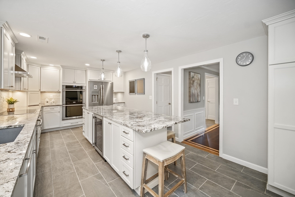 5 Strawberry Lane Norfolk, MA 02056 - Photo 8 of 42 a large kitchen with kitchen island granite countertop lots of counter top space and stainless steel appliances
