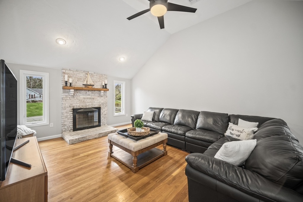5 Strawberry Lane Norfolk, MA 02056 - Photo 10 of 42 a living room with furniture and a fireplace