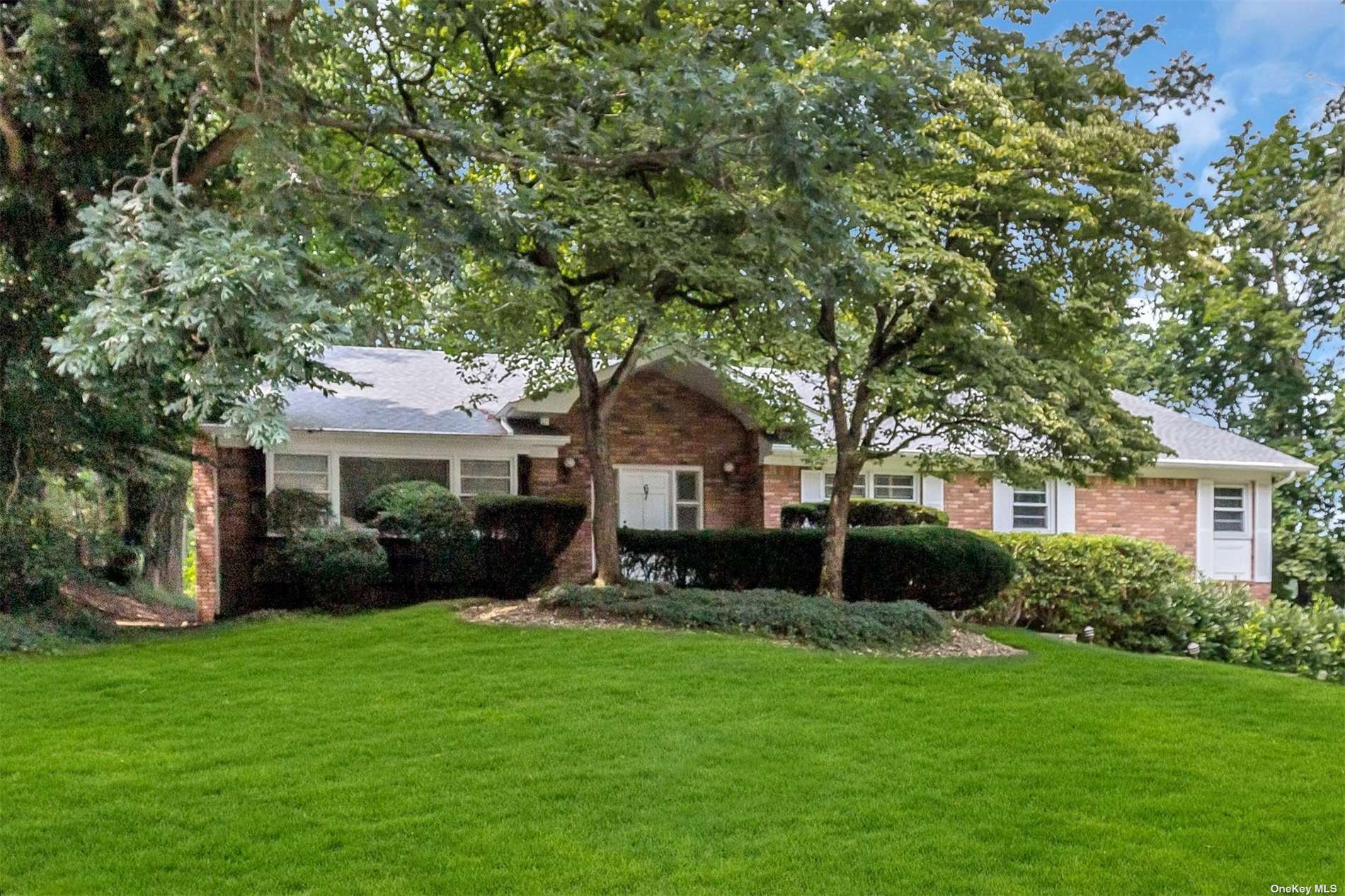67 Flamingo Road East Hills, NY 11576 - Photo 1 of 1 a front view of a house with a yard and green space