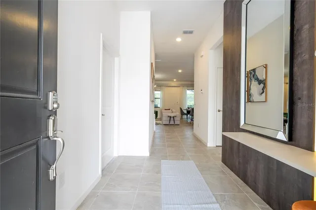 a kitchen with a table chairs sink and cabinets